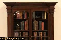   this grand and imposing victorian period bookcase has burl panels the