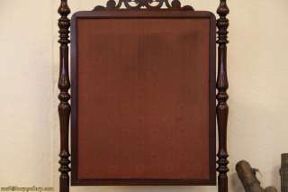 An authentic Victorian fireplace screen was carved of solid mahogany 