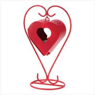   dash of romance from a bright red finish and heart shaped candle cage