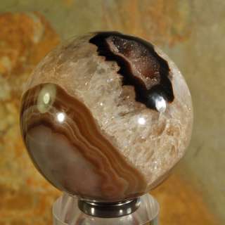 You are considering a beautiful agate geode sphere with a hematite 